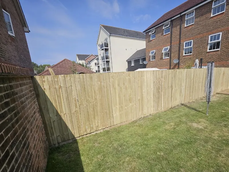 Long run of new closeboard fencing along a lawn