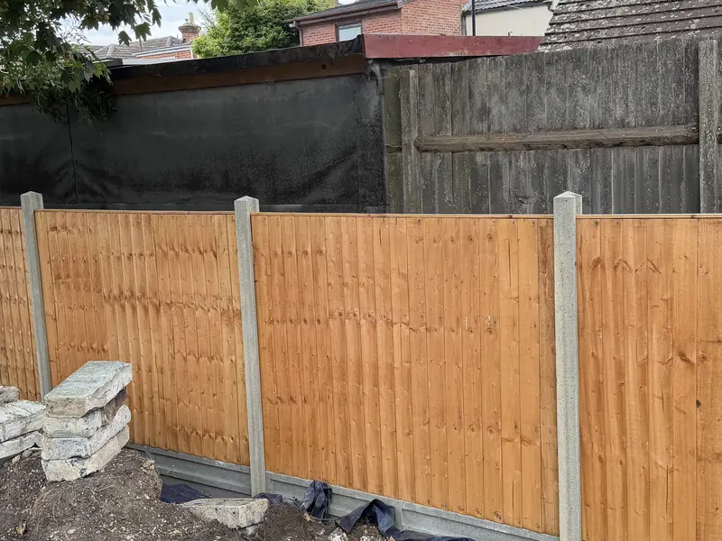 Fence between concrete posts with concrete gravel boards